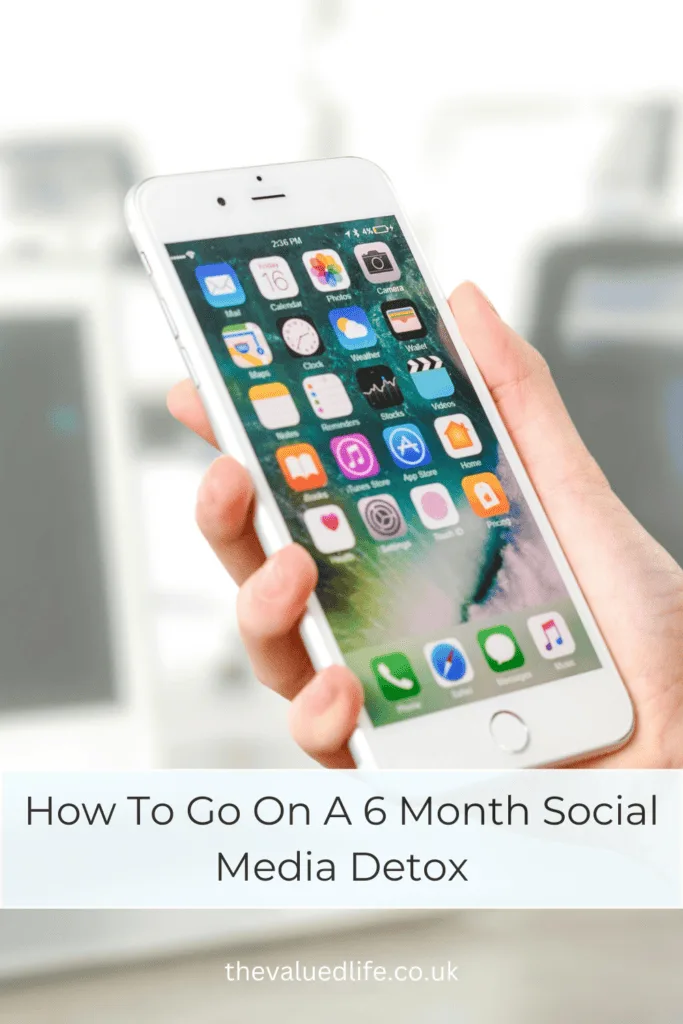 a hand holding an iphone with text overlay 'how to go on a 6 month social media detox'