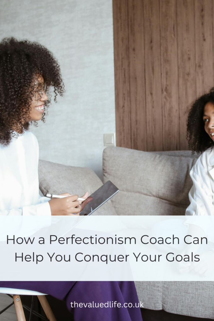 The side profile of two ladies sitting on a chair talking. With the title overlay 'How a Perfectionism Coach Can Help You Conquer Your Goals'