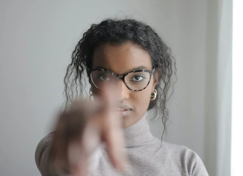 a woman pointing at the camera - identify your values