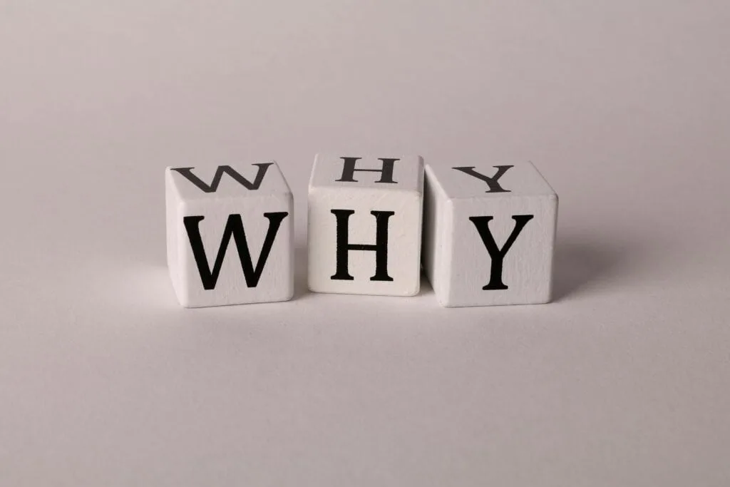 scrabble cubes spelling out the word why