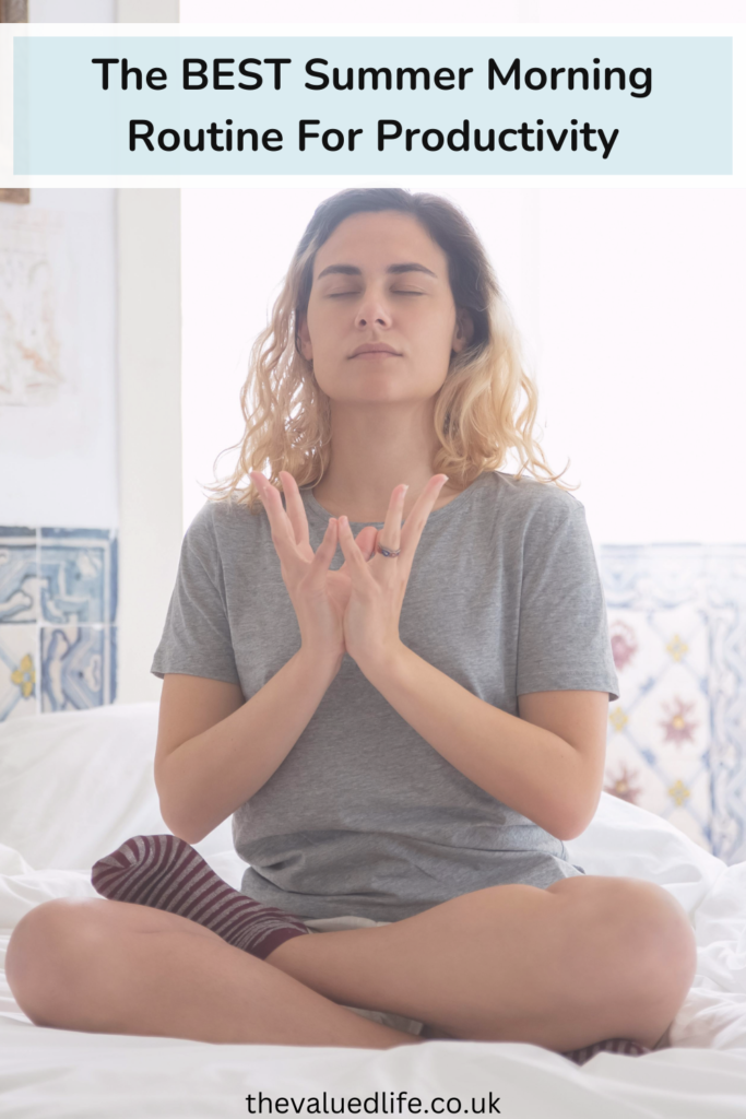 a woman sitting cross-legged on a bed with her eyes closed in a form of meditation pose as part of a summer morning routine