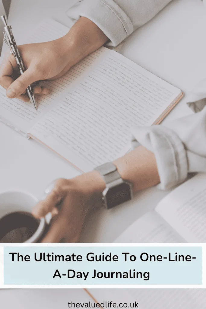 Person Writing in a one line a day journal While Holding Coffee Mug