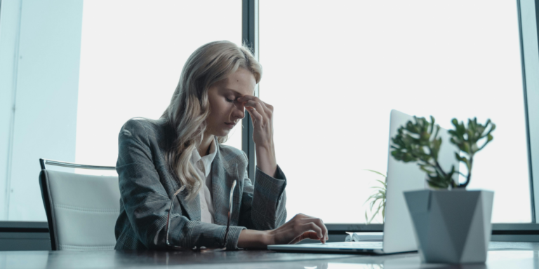 Woman Stressed at Work to highlight signs you're a perfectionist