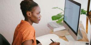 Woman Looking at a Computer trying to identify where does perfectionism come from