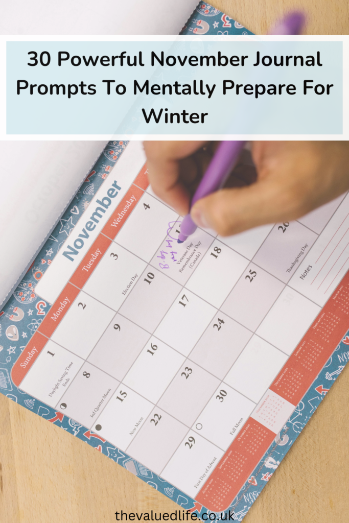 Person Holding Purple Click Pen writing on a calendar page for november journal prompts