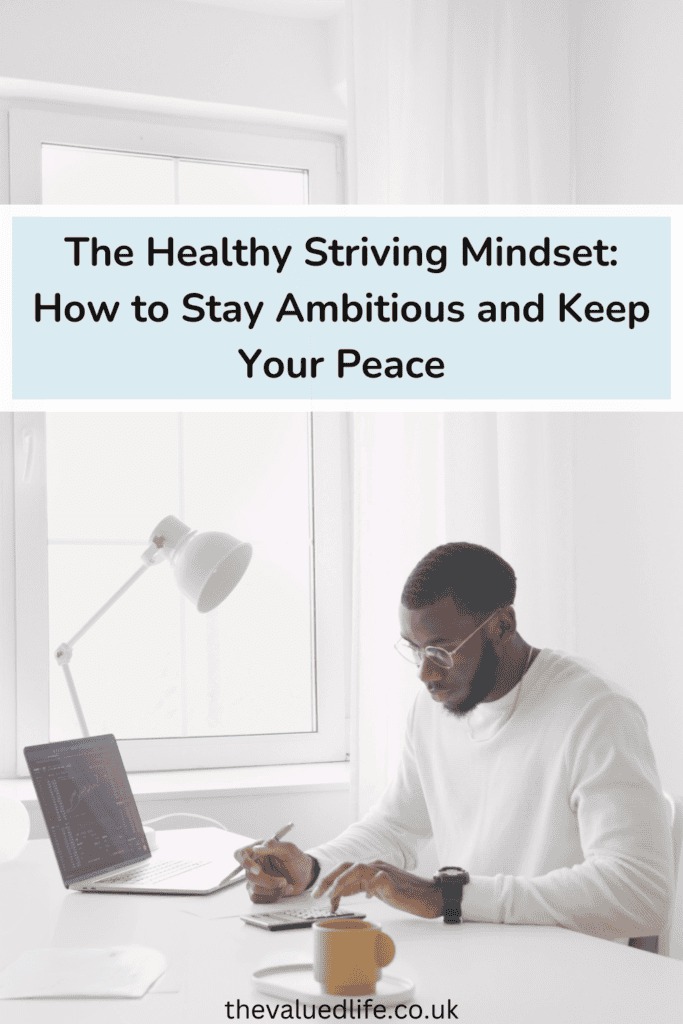 Person working calmly at a minimalist desk with a laptop, calculator, and coffee cup, embodying the concept of healthy striving. The bright, peaceful workspace reflects a balanced approach to productivity and well-being.