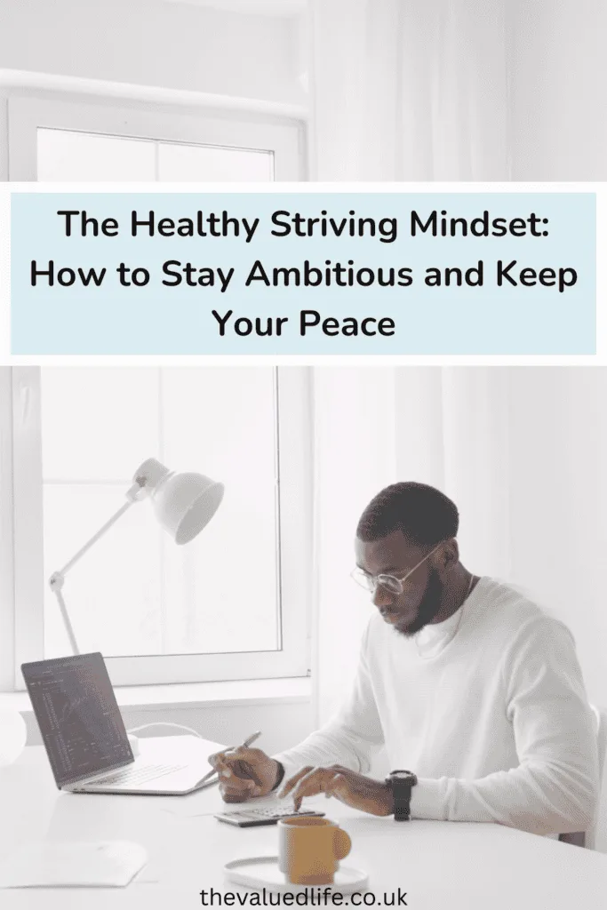 Person working calmly at a minimalist desk with a laptop, calculator, and coffee cup, embodying the concept of healthy striving. The bright, peaceful workspace reflects a balanced approach to productivity and well-being.