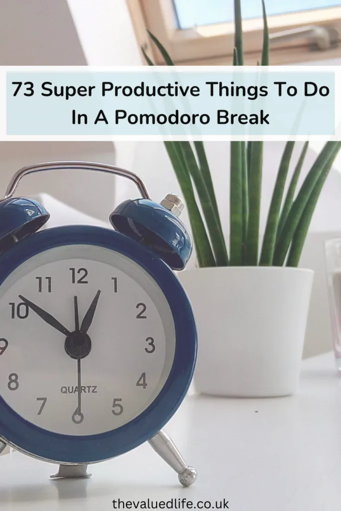 A blue alarm clock set at 10:10 on a white table with a potted plant and a layered candle in the background. Text overlay that says '73 Super Productive Things To Do In A Pomodoro Break'